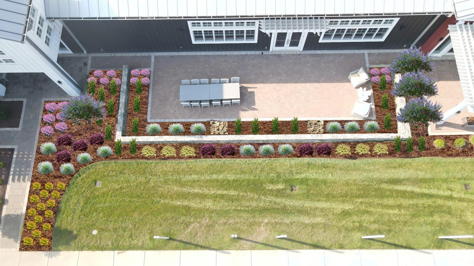 Lakefront home after CLP landscape renovation — lush lawn with colorful plantings